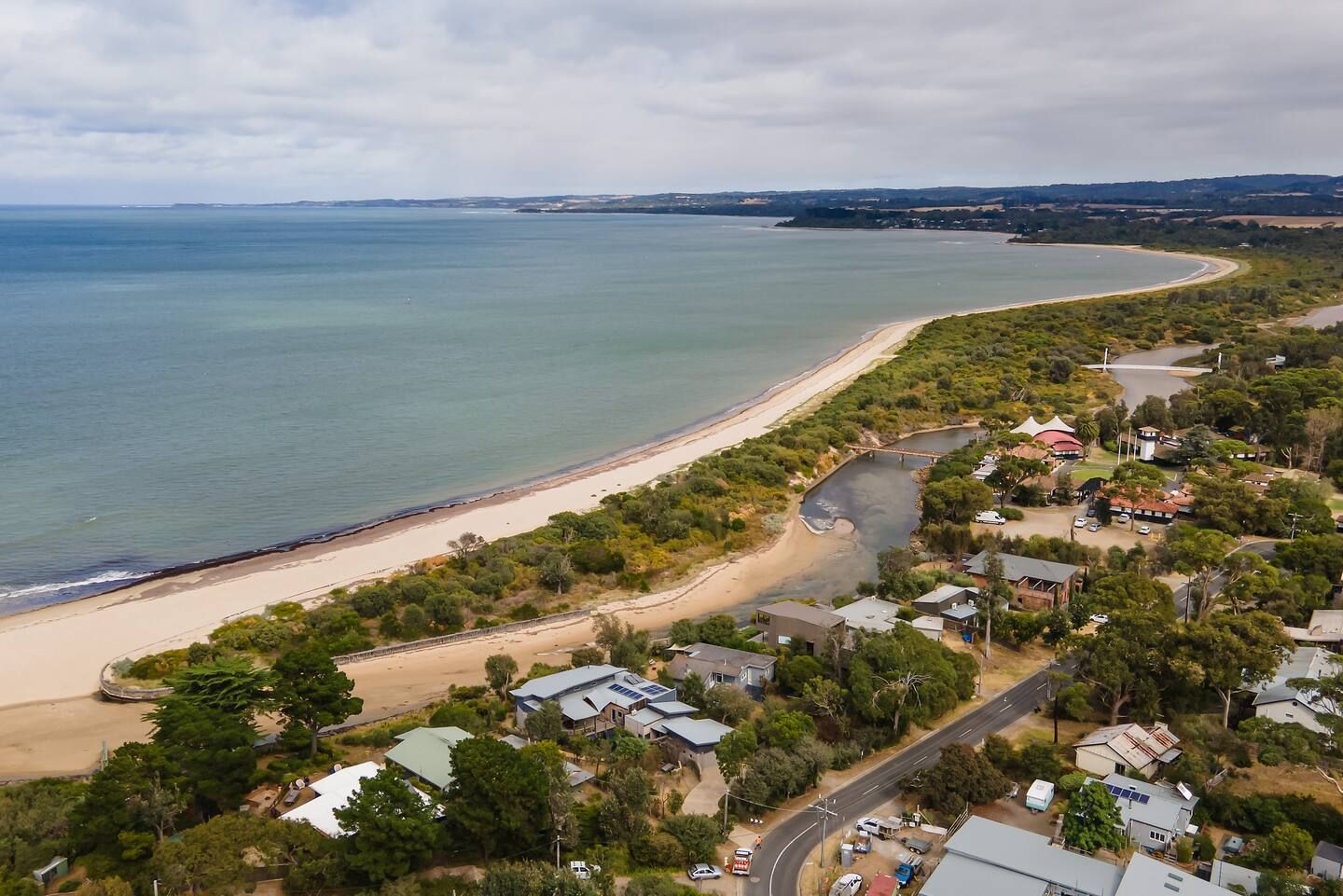 Aerial view of Somers beach and the Merricks Creek mouth, with the village behind the dunes