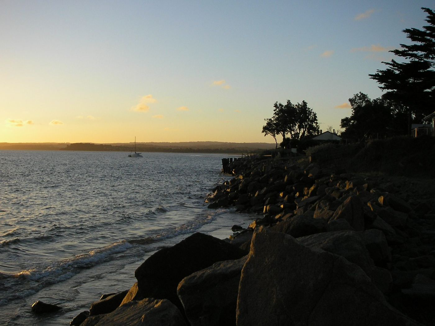 Sun setting over Western Port from the rocky shoreline at Somers on the Mornington Peninsula